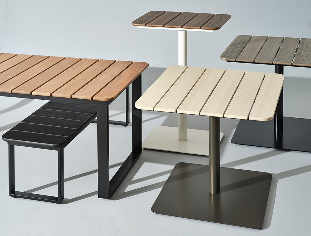 Various tables from the Bowen Outdoor Collection in different sizes and outdoor finishes
