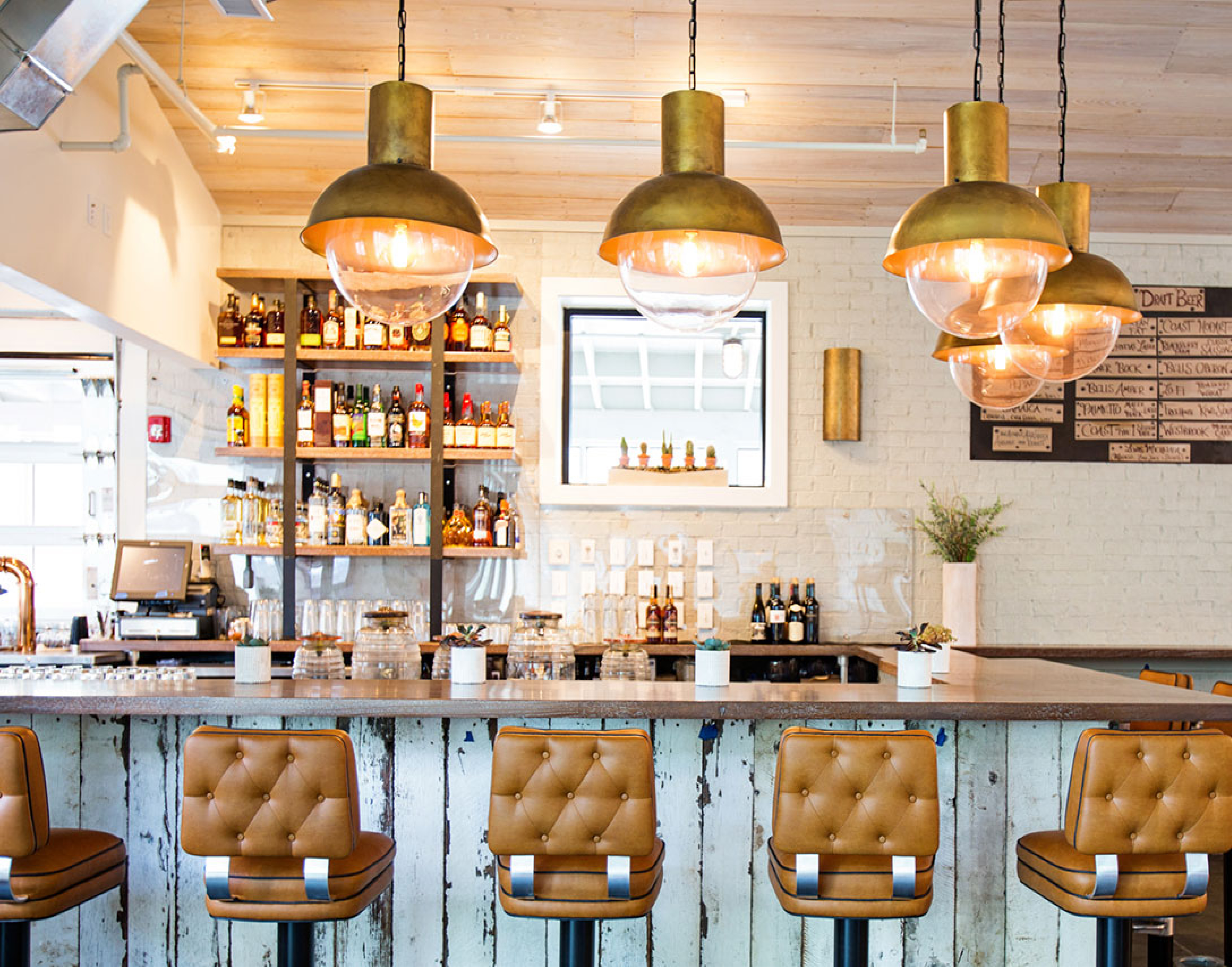 Lewis BBQ interior bar design with upholstered barstools