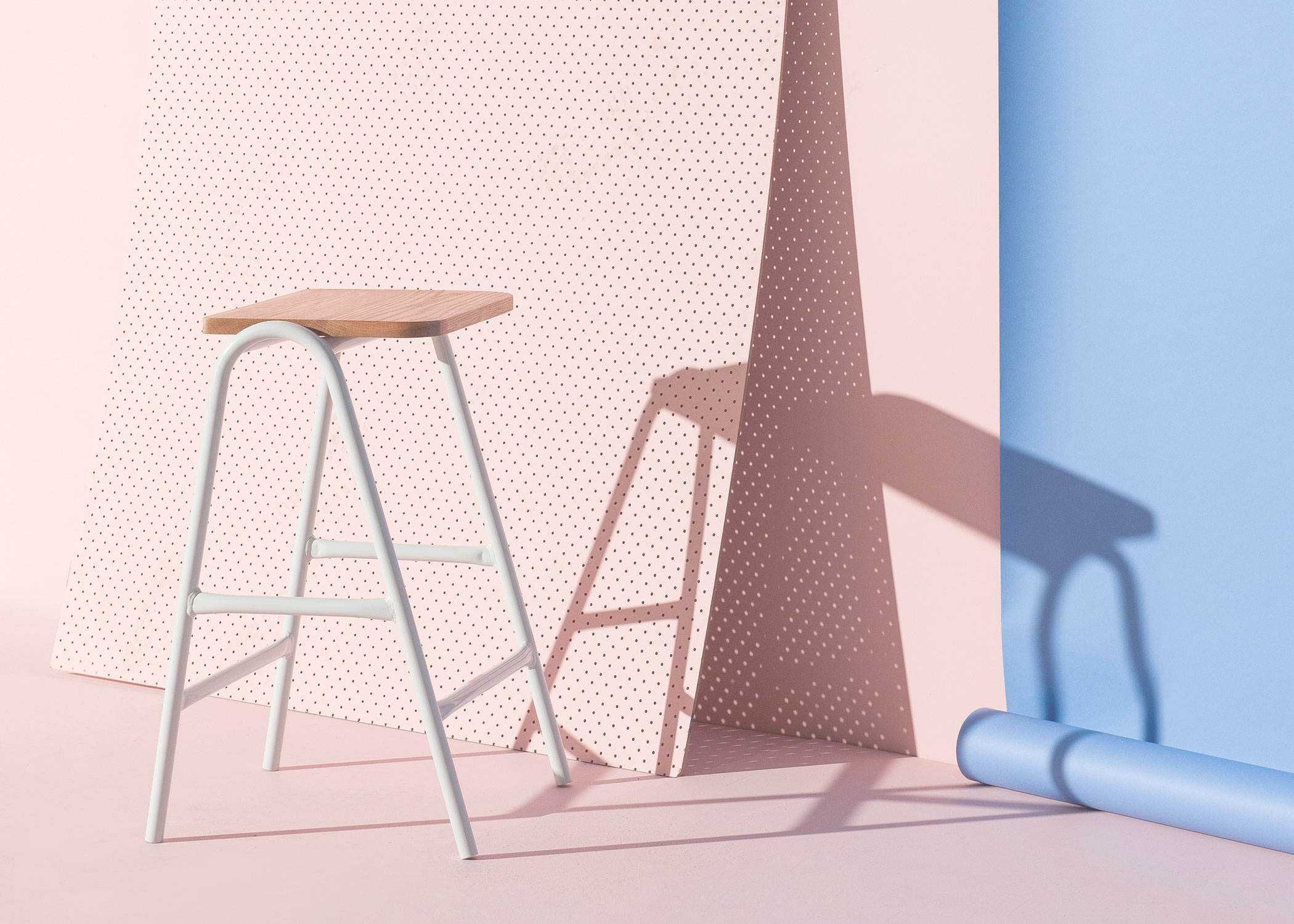 Modern Hurdle Barstool against a light pink and sky blue backdrop