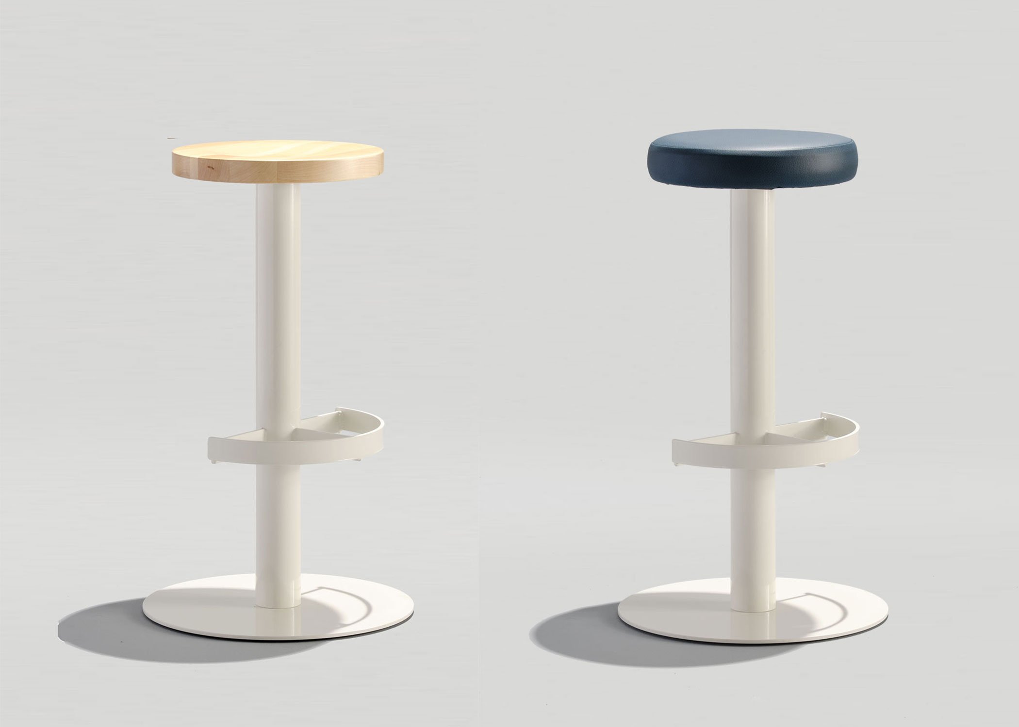 Two Freestanding Sally Stools in white powder coats. Left stool has a wood seat. Right stool's seat is upholstered.